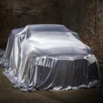 Car under a tarp in a barn for winter storage