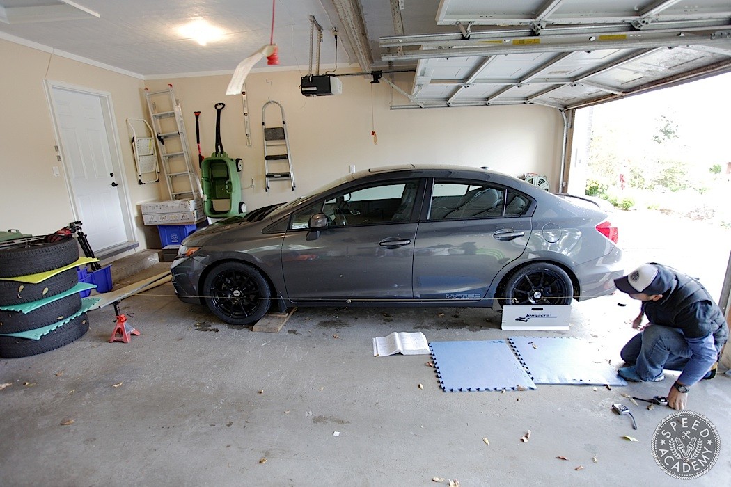 Toe plates being used to measure wheel alignment, a DIY approach for car enthusiasts.