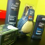 Dove Men+Care product swag including deodorant, body and face wash, bar soap and shower tool