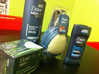 Dove Men+Care product swag including deodorant, body and face wash, bar soap and shower tool