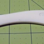 Close up of a Hera marker tool used in quilting and sewing to create crease lines on fabric.