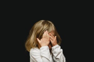 child covering face