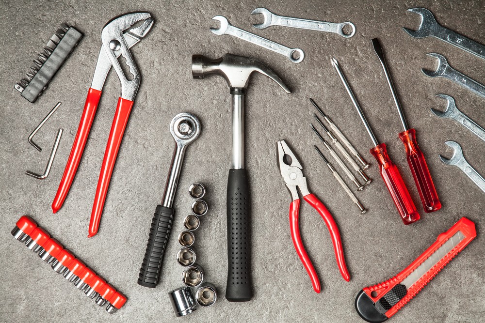 Essential tools for a car tool kit including socket set, wrenches, screwdrivers, pliers, and safety gear, highlighting preparedness for vehicle maintenance and repairs.