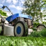 Professional lawn mower cutting green grass in backyard.