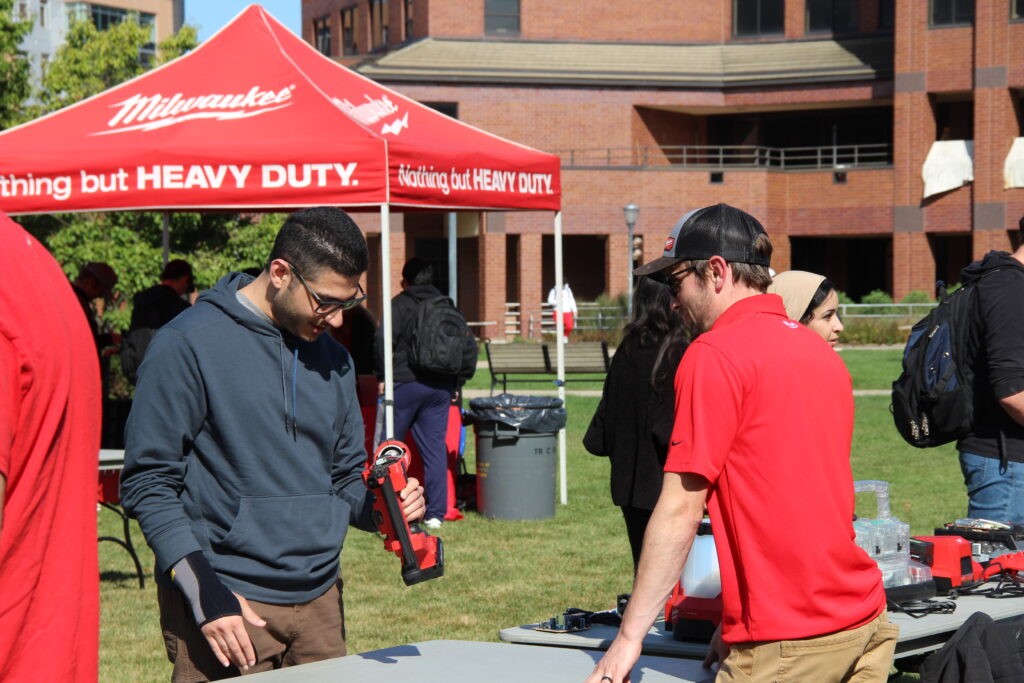 Milwaukee Tool employee interacting with students at Tool-A-Thon.