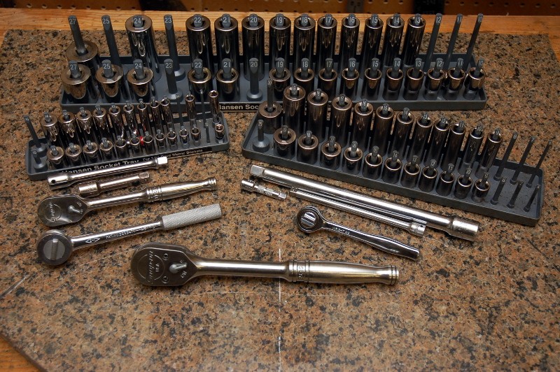 A car tool kit with various wrenches, sockets, and screwdrivers.