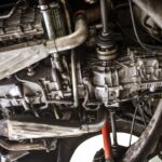 alt text: Dry ice blasting equipment setup with a technician preparing to clean a car part.