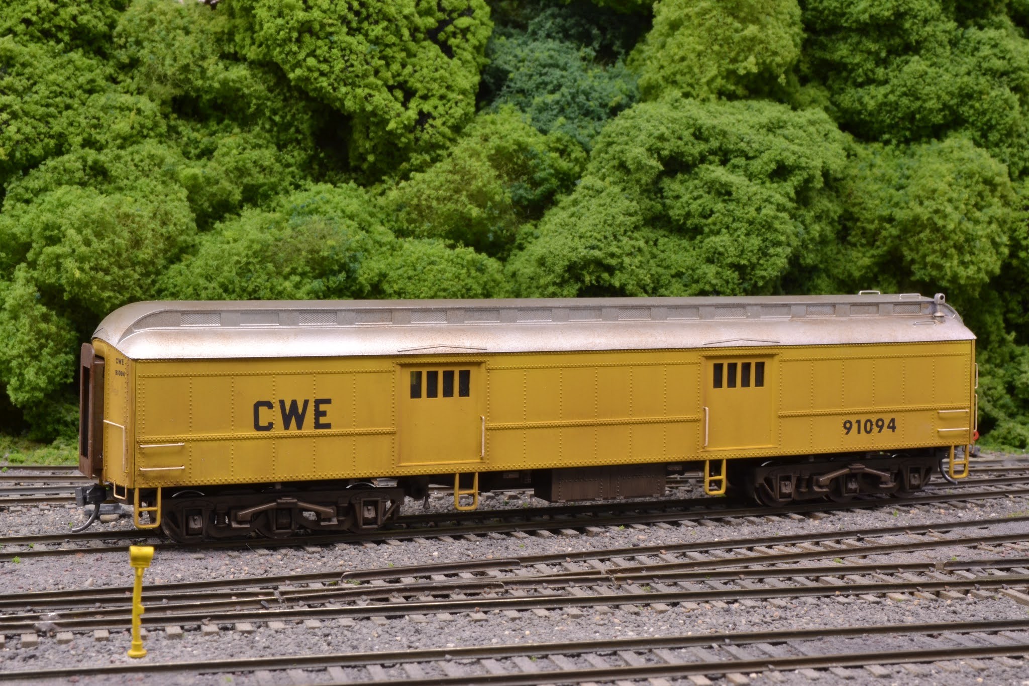 The finished railroad tool car in armor yellow with white grab irons.